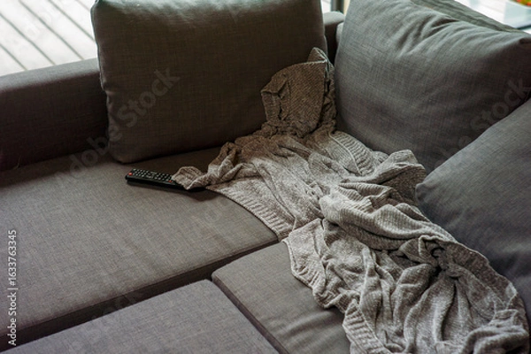 Fototapeta couch with a crumpled blanket