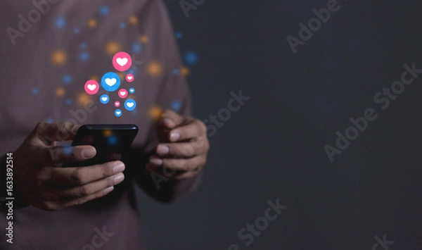 Fototapeta Love And Like Social Media Concept, Young Man hand using smart phone mobile, with Social Media, on soft blurred background