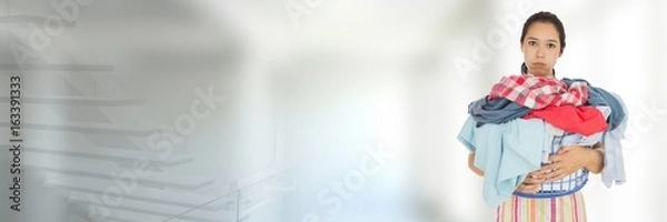 Obraz Cleaner holding laundry basket with bright background