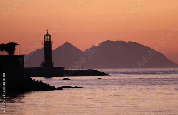 Fototapeta Vigo Lighthouse with the Cies Islands in the background at sunset