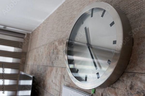 Fototapeta clock hangs on the wall in the room