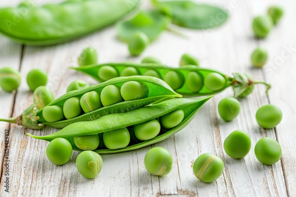 Fototapeta AI-generated fresh green peas scattered on light wooden kitchen table, some in open pods and loose shelled peas, soft natural morning light, cozy farm-to-table vibe.