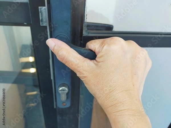 Obraz hand opening a door handle
