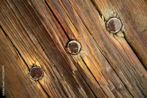 Obraz Three large nails in old weathered boards
