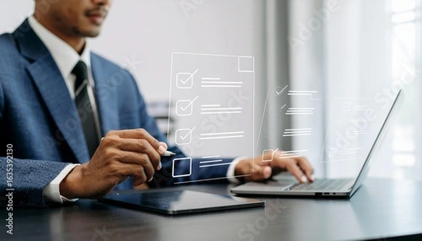 Fototapeta Confident entrepreneur reviewing digital checklist on laptop in modern office for business strategy success