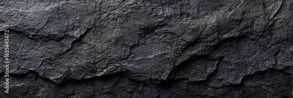 Fototapeta Close-up view of dark gray stone surface with textured layers