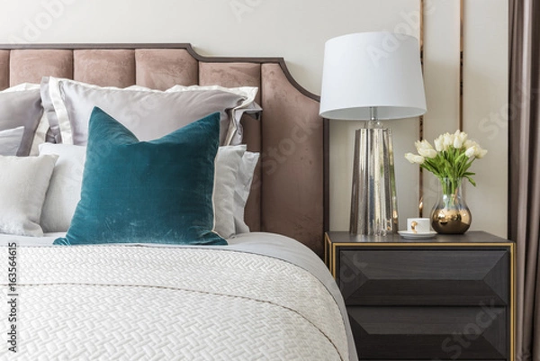 Fototapeta classic bedroom style with set of pillows and lamp on table side