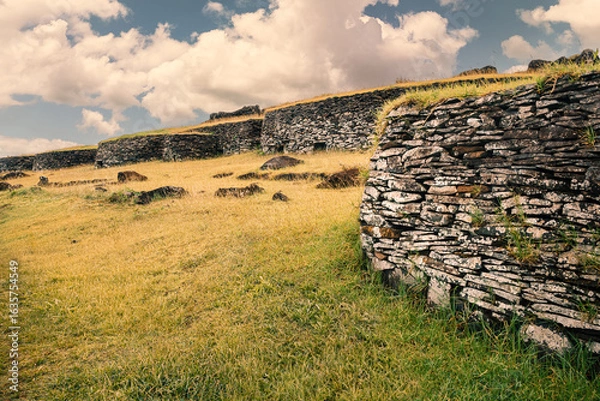 Obraz Stone houses in the Orongo ceremonial village, Rapa Nui (Easter Island), Chile, built using laminar basalt slabs collected from the edges of the nearby Rano Kau crater.