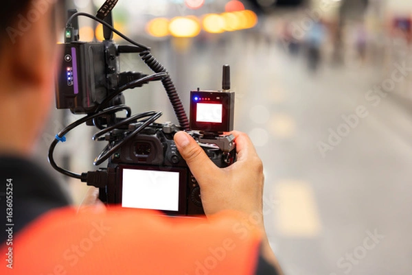 Obraz Cameraman Recording Video with Professional Equipment