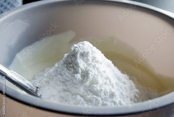 Fototapeta Powdered or icing sugar in plastic bowl.