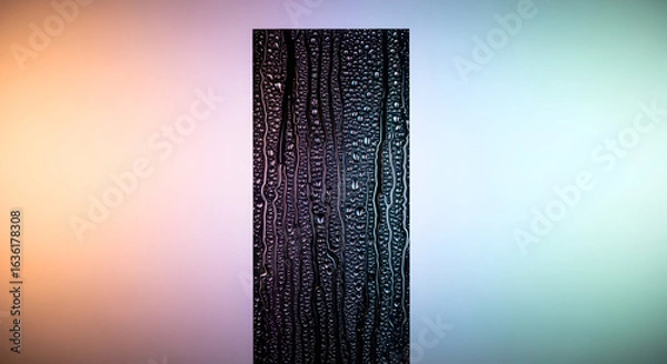 Fototapeta Abstract Rain Streaks on Dark Vertical Panel Against Soft Gradient Background. Water Droplets and Textured Surface with Blurred Colorful Hues.