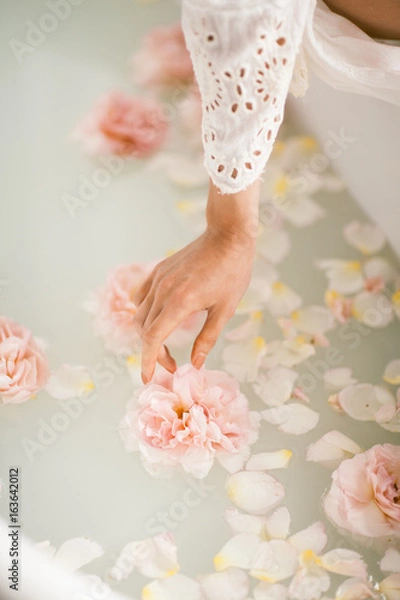 Obraz White bath with milk and rose petals. Relaxation and harmony
