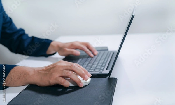 Fototapeta Business man hands typing on laptop computer keyboard, searching information,distance job, online working, business and technology concept.