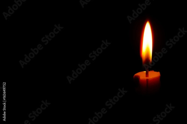 Fototapeta isolated Burning Candle In The Dark