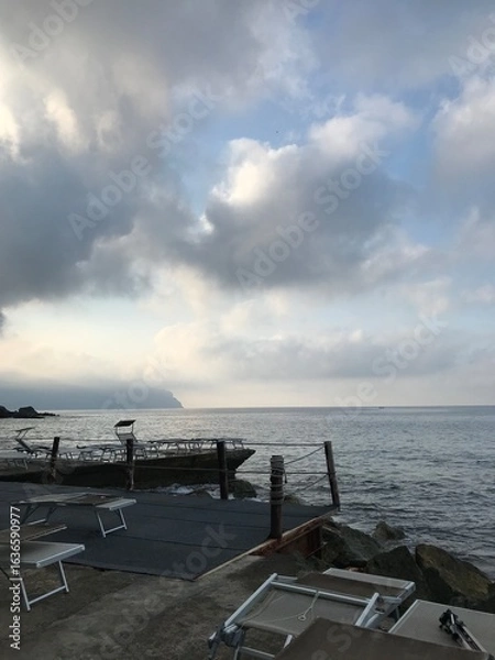 Obraz Waves rolling onto a stony beach in summer.
