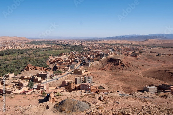 Fototapeta Morocco - panoramic view on the Tinghir oasis, large area with palm trees and the town.  North Africa
