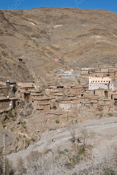 Fototapeta Morocco - Ancient poor village, clay architecture. Small valley on the road from Marrakech and Sahara,  North Africa
