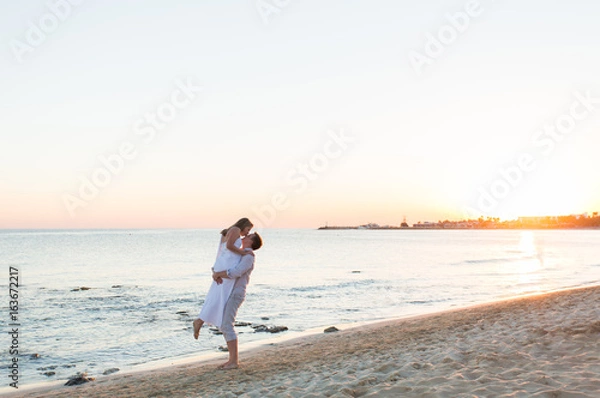 Fototapeta loving couple on the beach