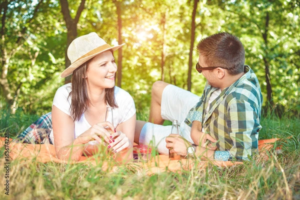 Fototapeta Happy Smiling Couple Relaxing in a Park Picnic