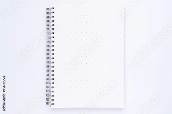 Fototapeta Top view of spiral notebook with dotted pattern pages