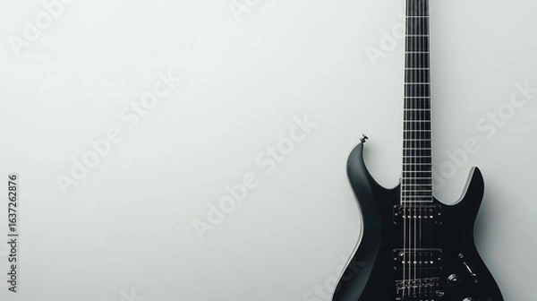 Fototapeta A sleek electric guitar with a modern design, space on the right for text, set against a white backdrop