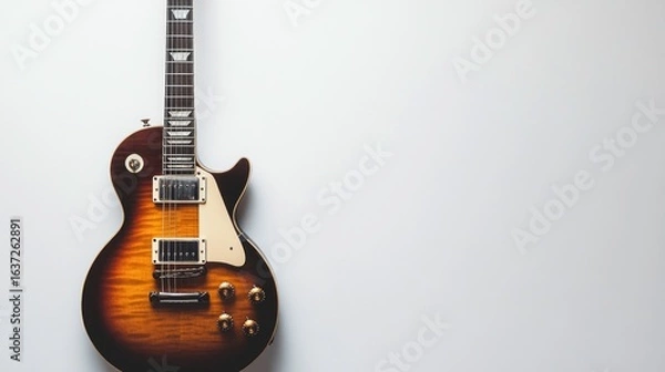 Fototapeta A sleek electric guitar with a modern design, space on the right for text, set against a white backdrop