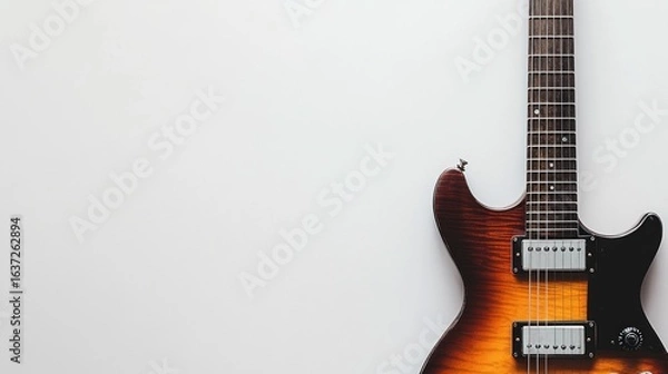 Fototapeta A sleek electric guitar with a modern design, space on the right for text, set against a white backdrop