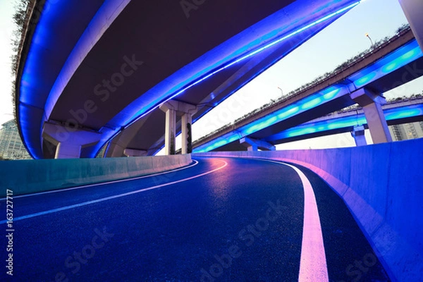 Obraz Empty road floor with city viaduct bridge of neon lights night