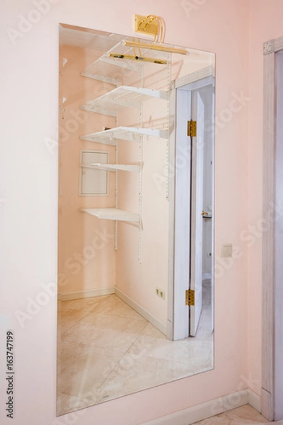 Obraz Empty walk-in closet with shelves. Dressing room Interior elements.