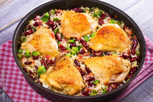 Obraz Chicken with Rice, Beans, Bacon and Green Pepper in Pan. View from above, top studio shot