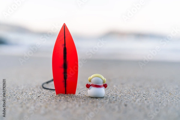 Fototapeta Sandy Christmas Snowman is watching the waves, standing on beautiful beach with a surf board - horizontal version in Patong Beach, Phuket, Thailand