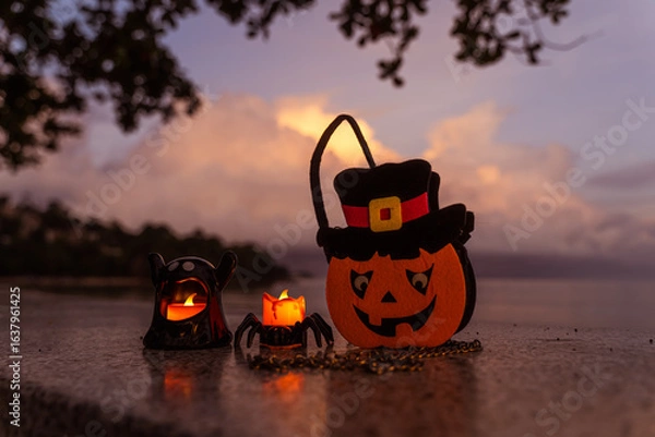 Fototapeta Concept: Halloween beach and ocean background with spider, witch and ghost pumpkin. Dark, scary tone.