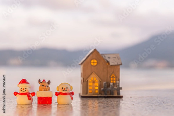 Fototapeta Merry Christmas word in wooden on the beach of tidewater green tone background, wide banner, Christmas banner, happy concept, copy space, soft focus Sky in the morning, Patong Beach, Phuket Thailand