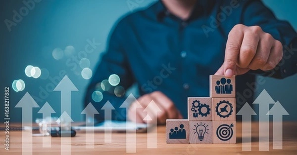 Fototapeta Businessman building blocks of business success with upward arrows for growth