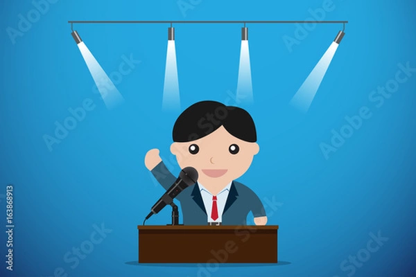 Fototapeta businessman speaking with microphone behind a table, speech and business concept