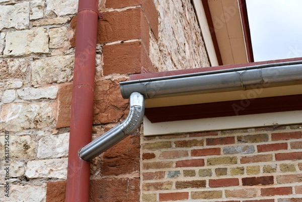 Obraz Modern gutter system linked with vintage downpipe.