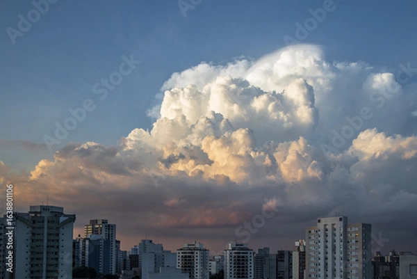Fototapeta dramatic sky with orange tones in a sunset with buildings in sao paulo with dramatic clouds in the sky