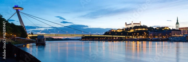 Fototapeta Bratislava, New Bridge, Castle, Cathedral during dusk from a boat on river Danube, panorama 3:1