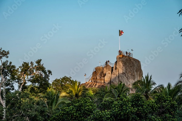 Fototapeta climbing on a rock in sri lanka, anouradhapura