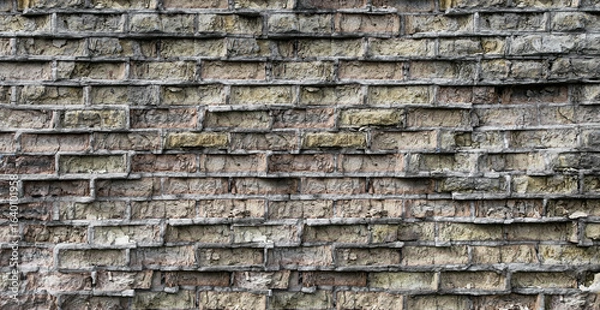 Fototapeta A brick wall damaged by time