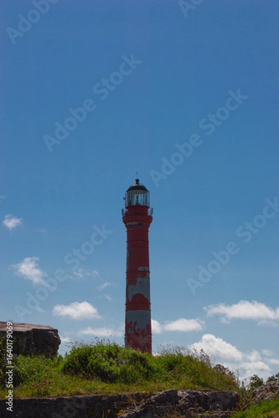 Obraz red lighthouse against blue sky
