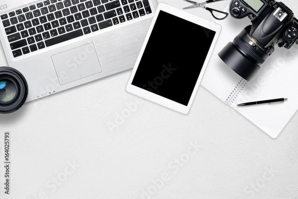 Fototapeta White office photography desk table with laptop, tablet, camera and glass. Top view with copy space