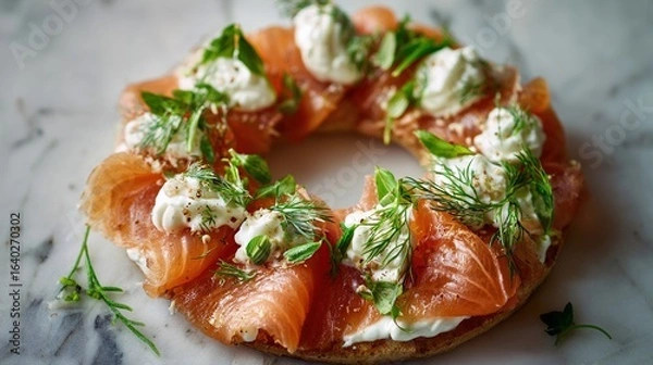 Fototapeta Close-up of a bagel topped with salmon, cream cheese, dill, basil, and microgreens, on marble