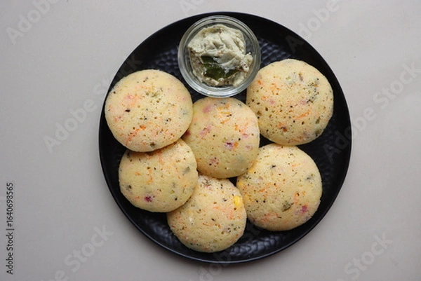 Obraz Rava Idli or semolina idli, Indian Breakfast Dish made with semolina, yogurt, spices, veggies,Traditional South Indian Breakfast, healthy vegetarian meal