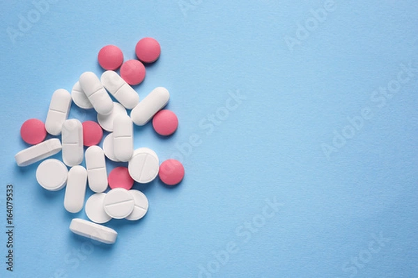 Fototapeta Different pills on color background
