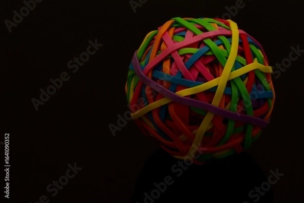 Obraz Colorful Rubber Band Ball with Reflection on a Dark Surface