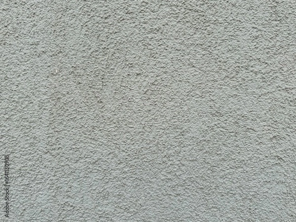 Fototapeta Horizontal light gray plaster wall with rough textured surface. Architectural background close-up, neutral construction material grungy old backdrop for design or copy space