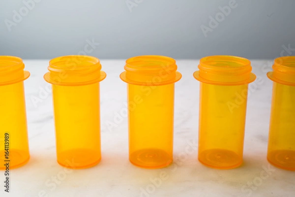 Fototapeta Five Prescription Vials, lined up on white
