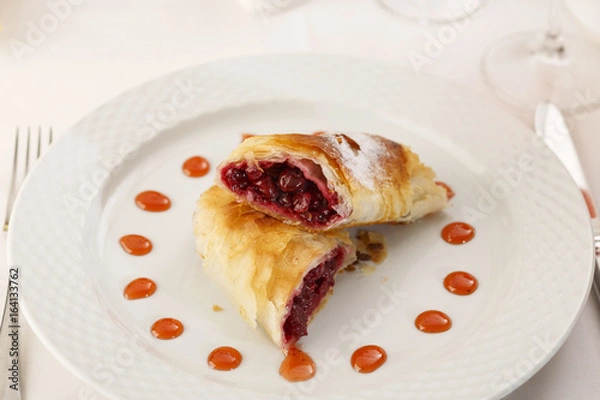 Fototapeta Cherry pie slice arranged on a plate, Traditional dessert in elegant setting, Selective focus with soft light