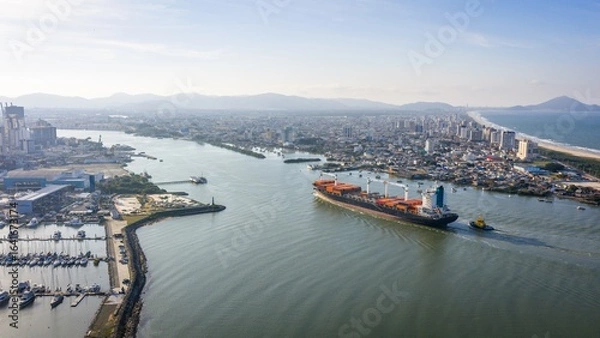 Obraz Aerial view of a cargo ship entering the Itajaí-Açu River between Itajaí and Navegantes, Brazil.
